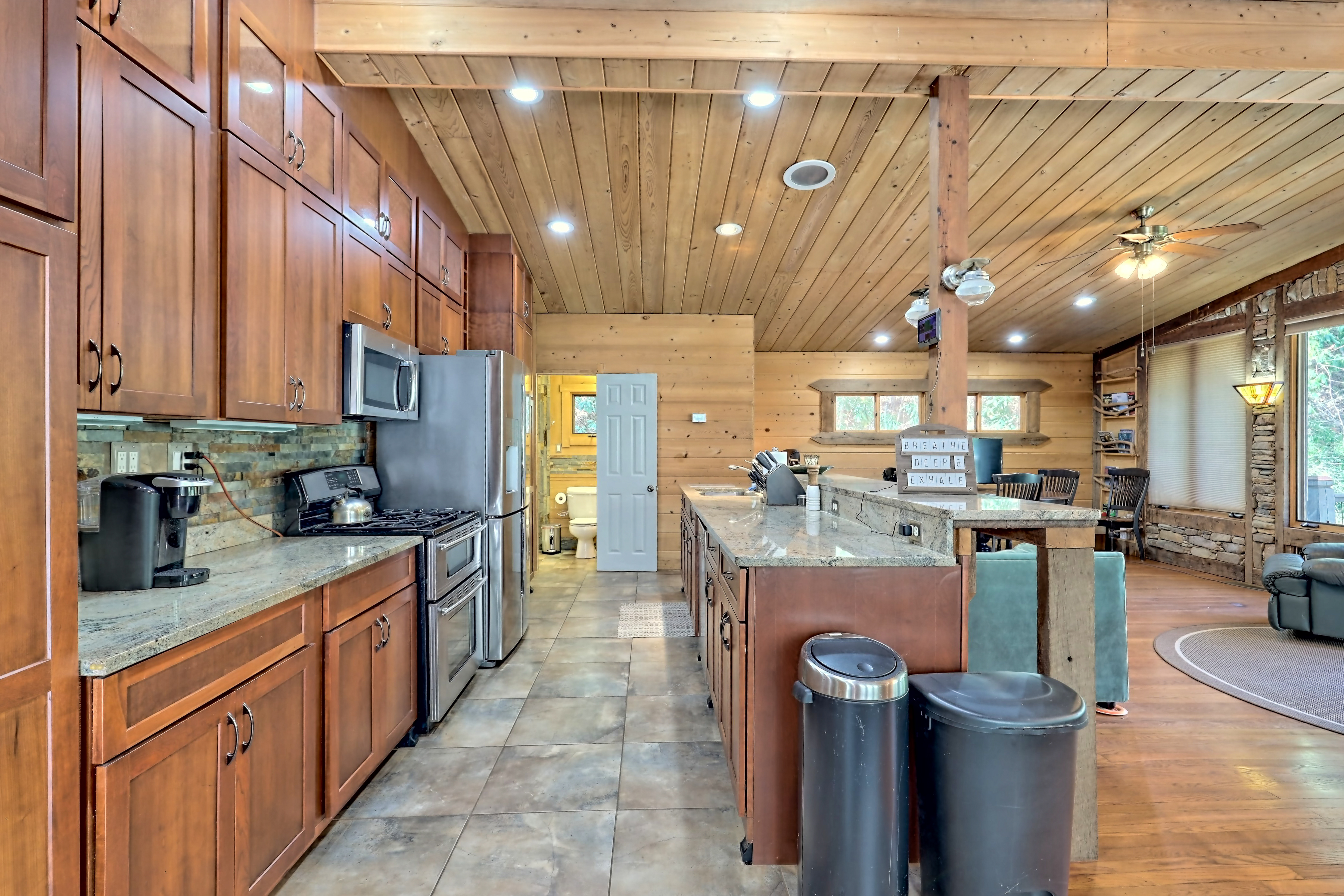 Rustic kitchen with wood cabinets and island